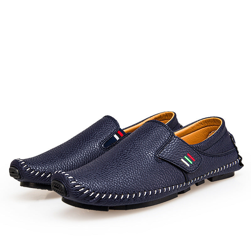 Pair of navy blue leather shoes with a white background