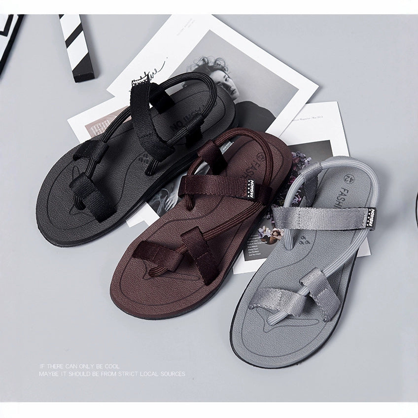 Three sandals in black, brown, and gray on a light gray background