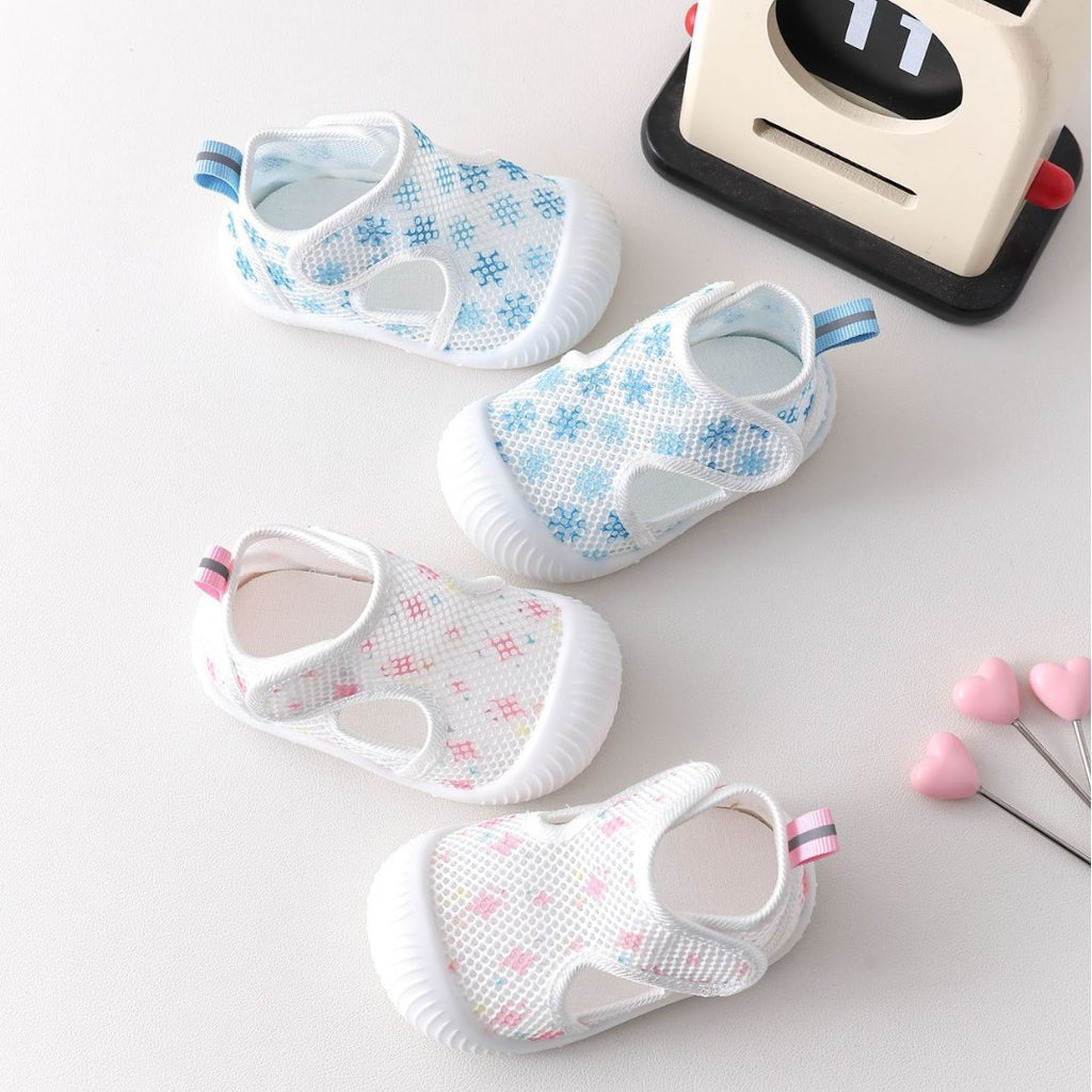 Set of baby shoes with floral patterns on a light background