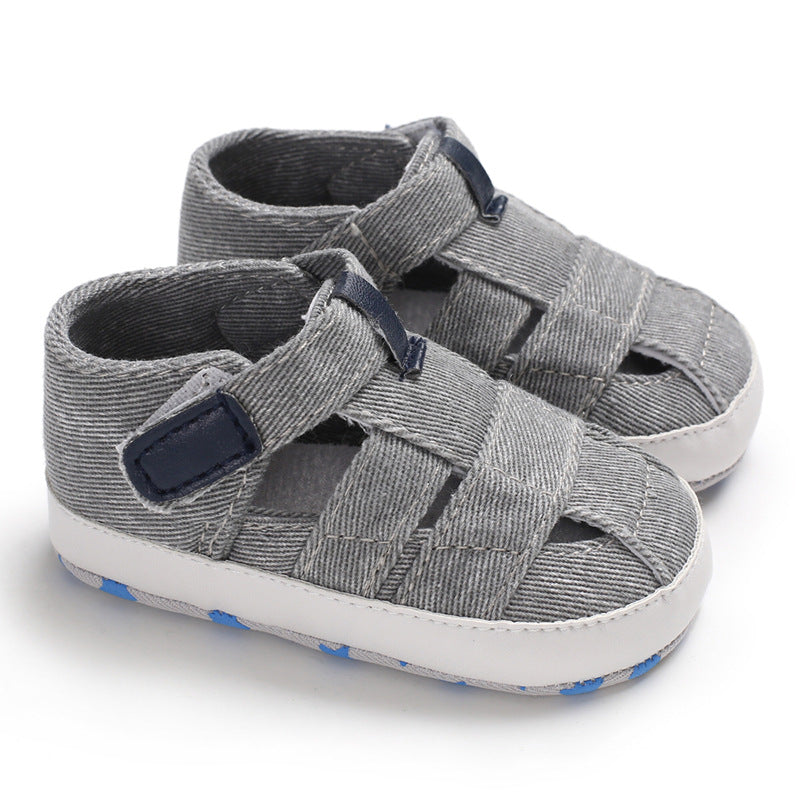 Gray sandals with navy straps on a white background