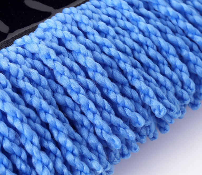 Close-up of blue microfiber cleaning cloth on a blurred background