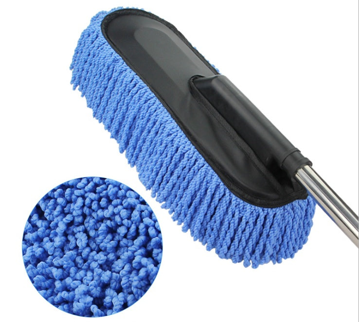 Microfiber cleaning brush with blue bristles and black handle on a white background