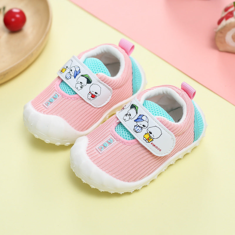 Pair of pink and teal children's shoes with cartoon character labels on a yellow and pink background.