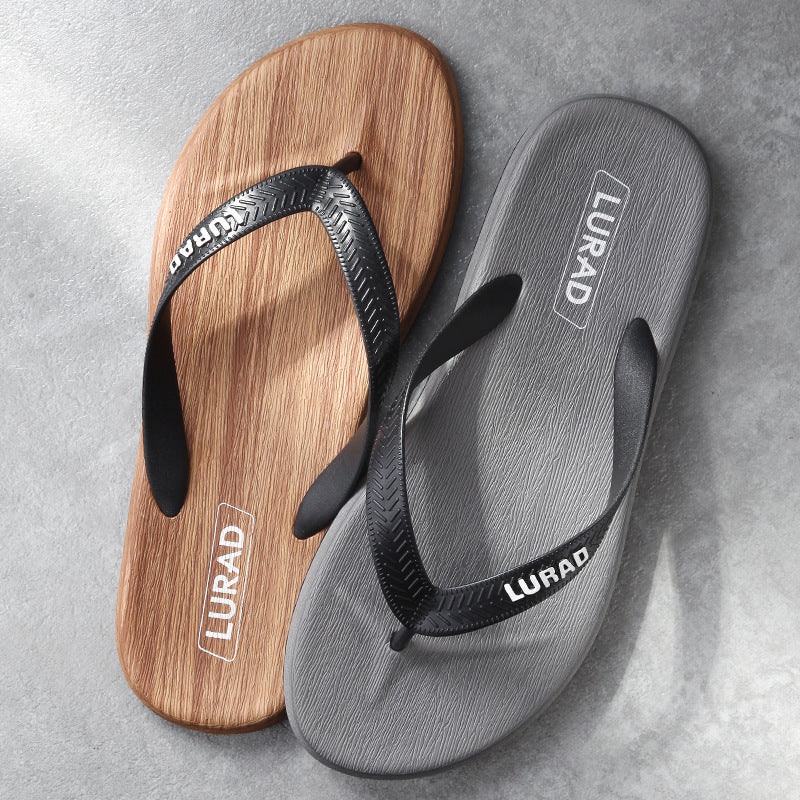 Two pairs of sandals, one wooden and one gray, on a gray surface with 'LURAD' branding.