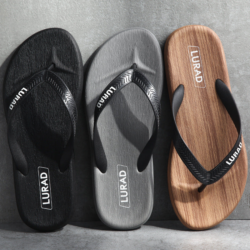 Three pairs of LURAD sandals in black, gray, and brown on a gray background