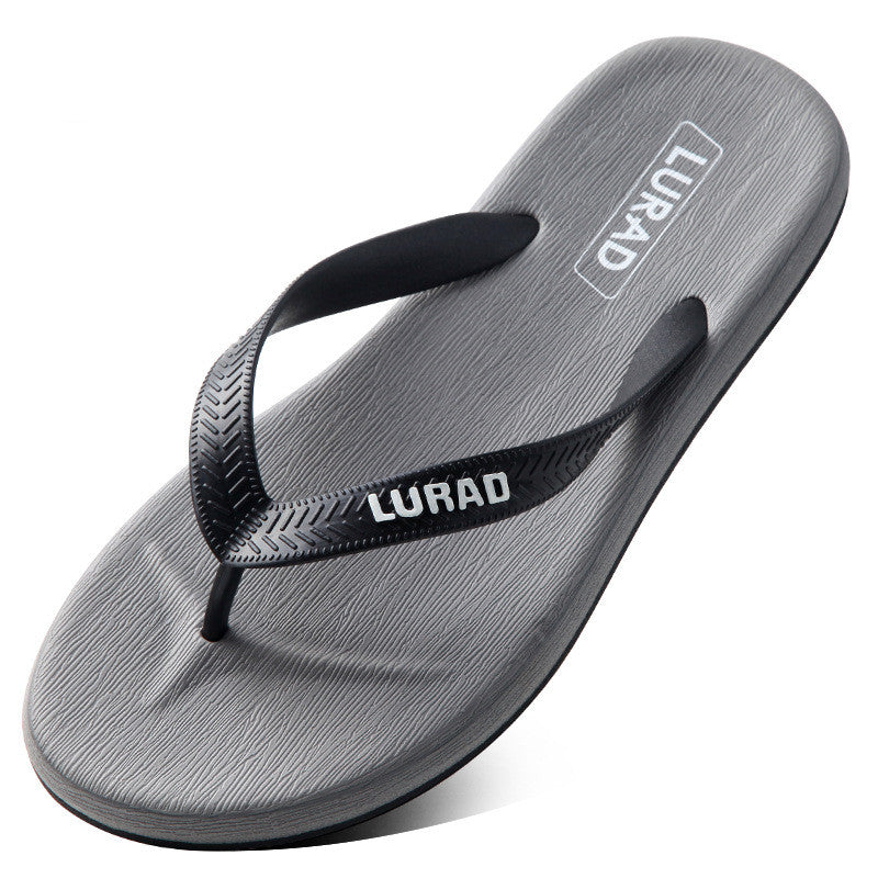 Gray flip-flop sandal with black strap on a white background