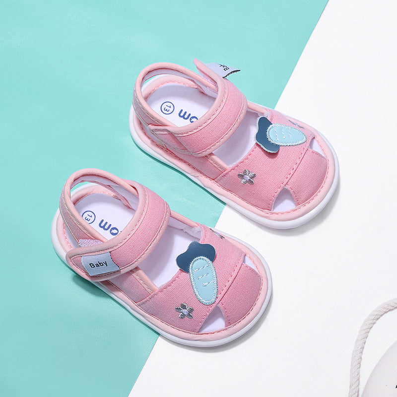Pink children's sandals with blue heart designs on a light blue and white background