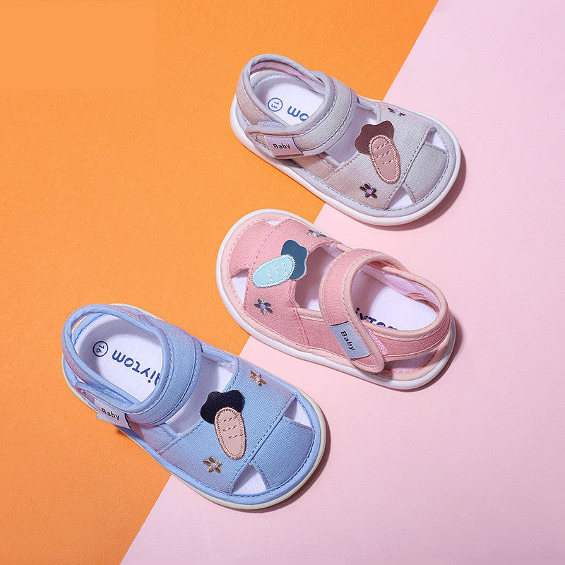 Three pairs of children's sandals in pink, blue, and gray on a two-tone orange and pink background.
