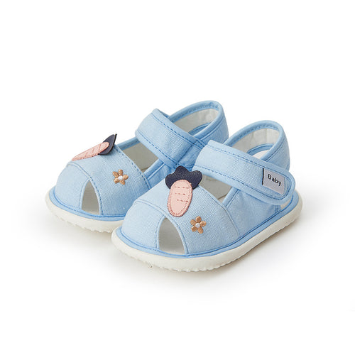 Pair of light blue baby sandals with decorative elements on a white background