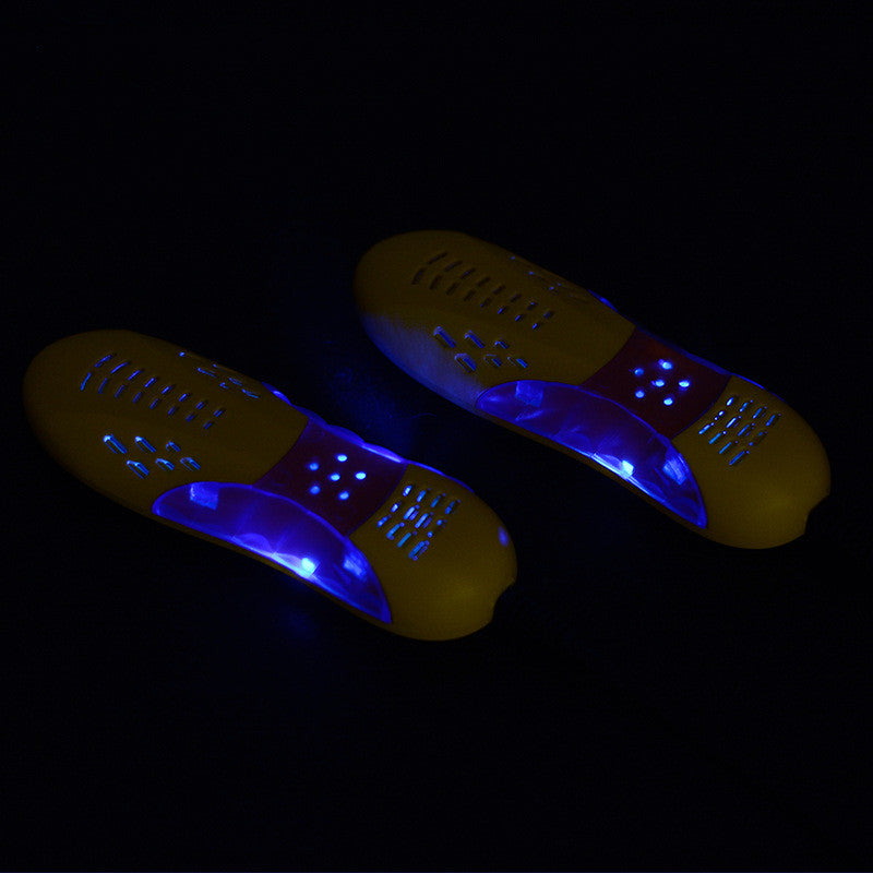 Pair of glowing yellow and blue shoe inserts on a black background