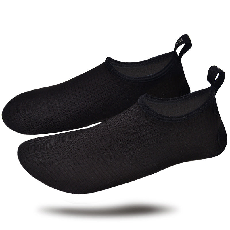 Pair of black water shoes on a white background