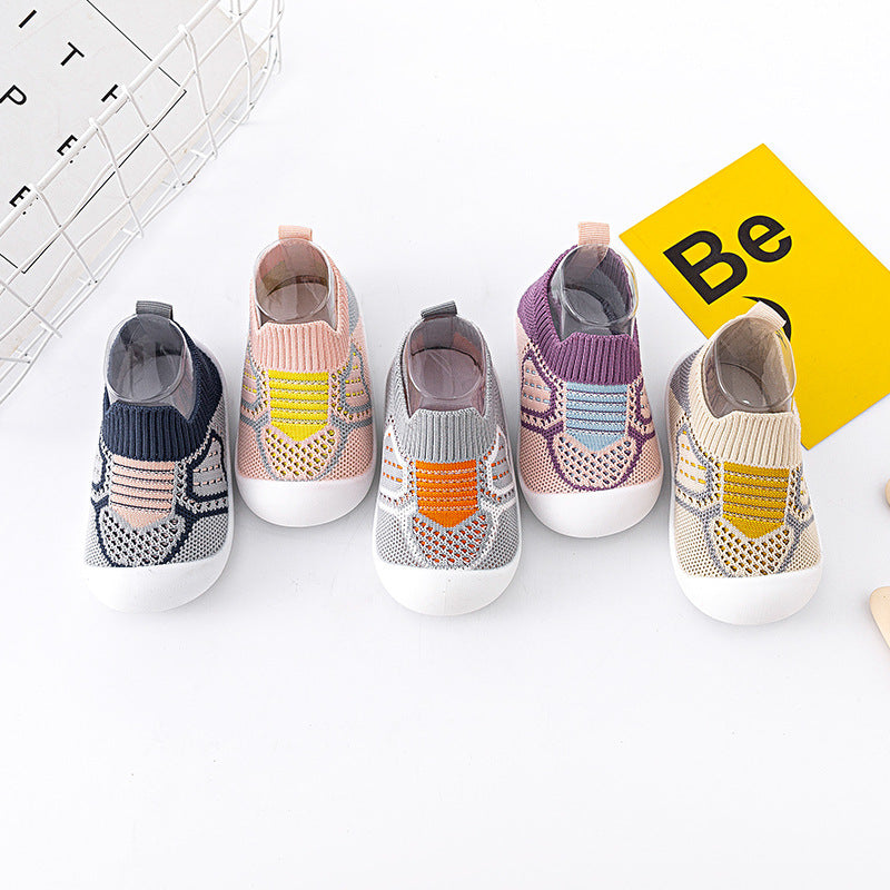 Colorful children's socks on a white background with a yellow sign.