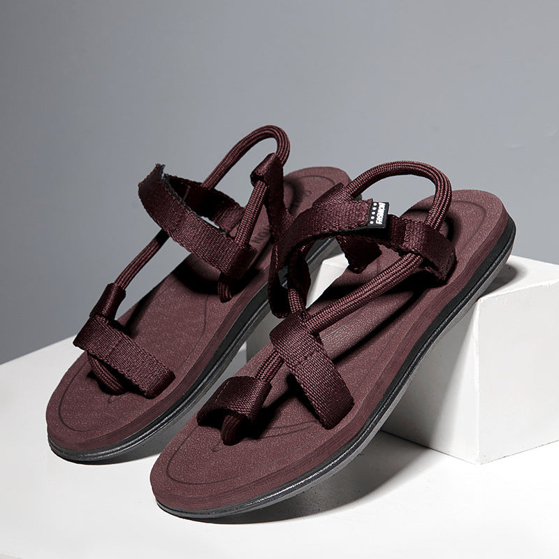 Pair of maroon sandals on a gray background