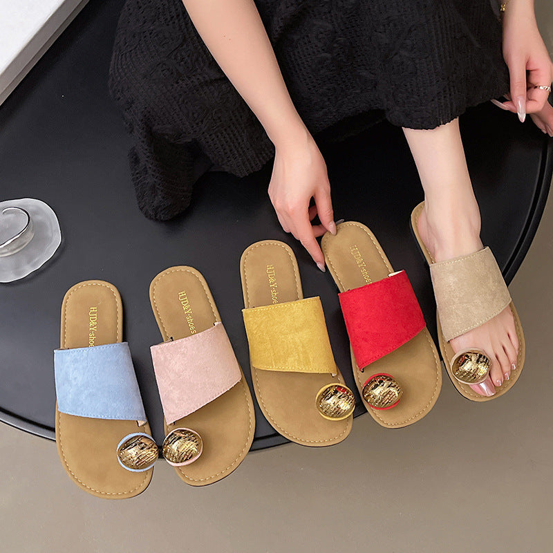 Set of colorful slippers with a person wearing one on a table.