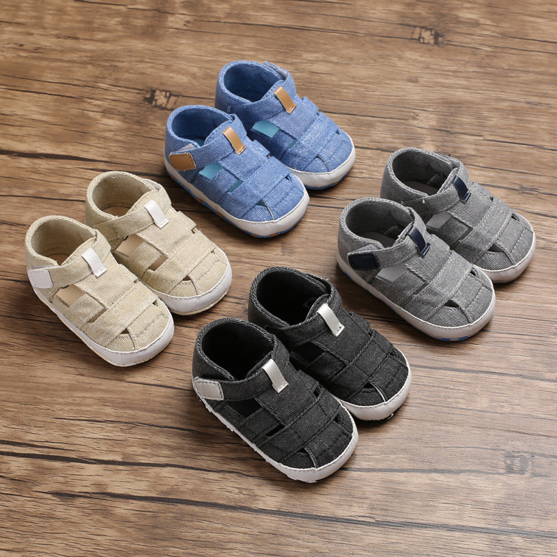 Set of children's sandals in blue, beige, and gray on a wooden surface