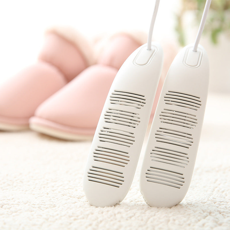 Two white hair dryers on a textured surface with a blurred background