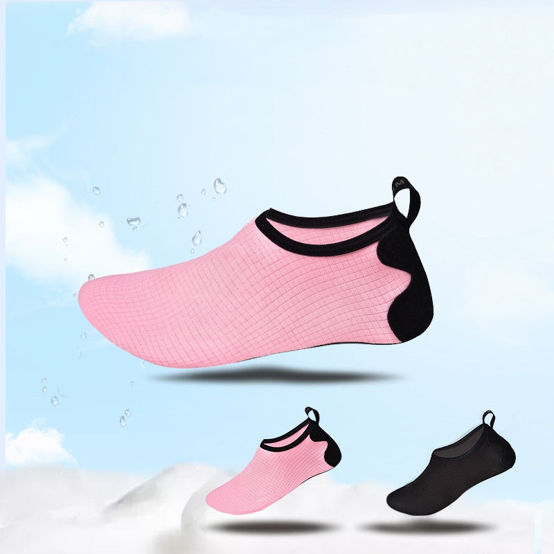 Pink and black water shoes on a light blue and white background