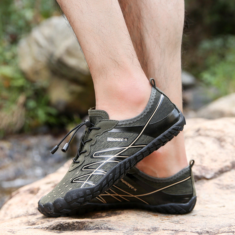 Black and green athletic shoes worn by a person on a natural background