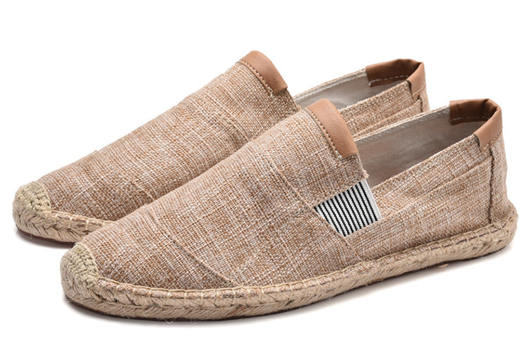 Pair of beige espadrille shoes on a white background