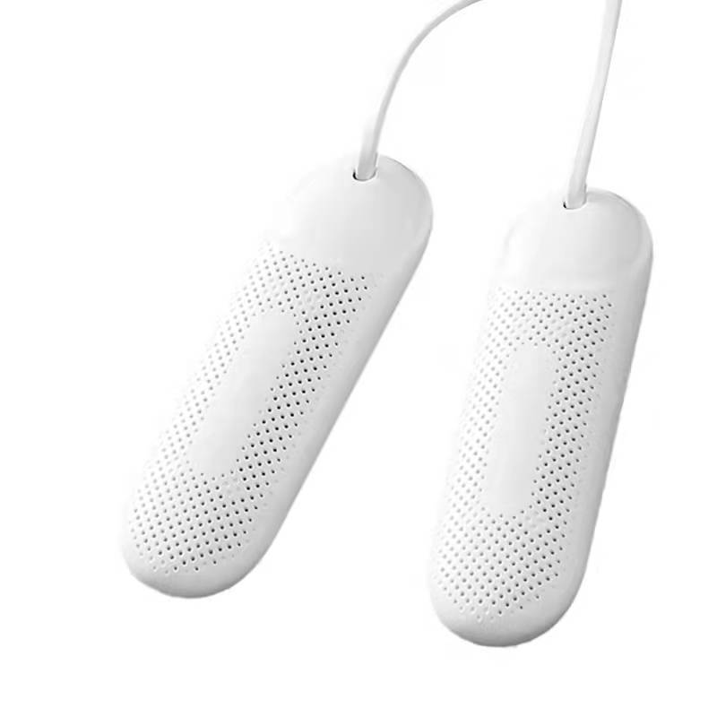 Two white shoe inserts with perforated design on a white background