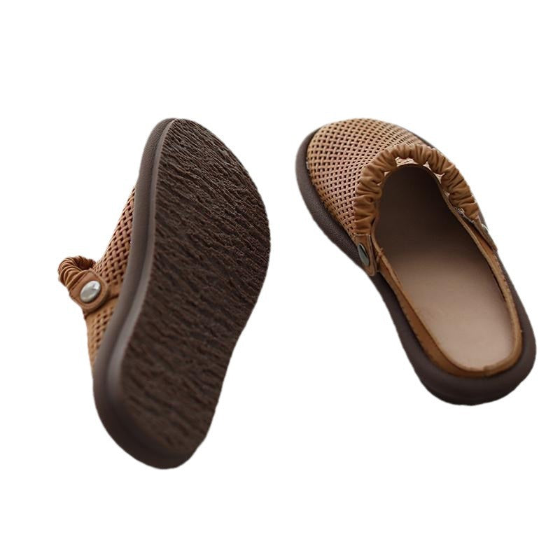 Pair of brown slippers with textured sole on a white background