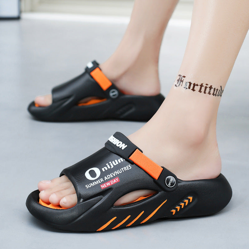 Black and orange sandals with visible branding on a neutral background