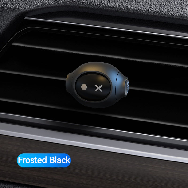 Frosted Black car air freshener on a car vent with a blue label