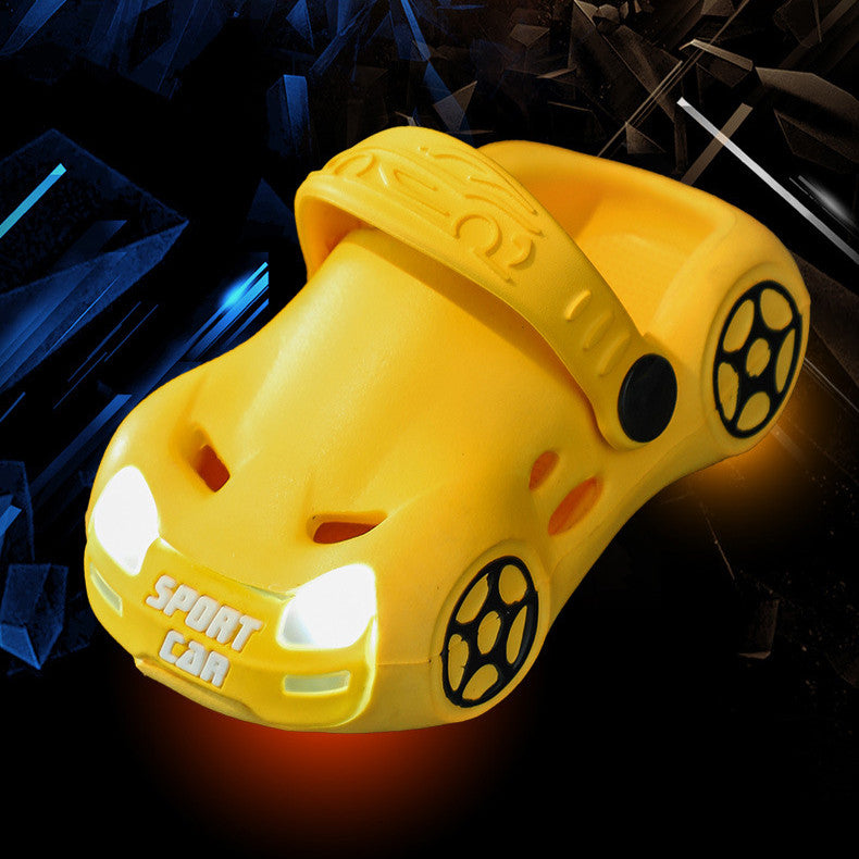 Yellow car-shaped clog shoe with 'Sport Car' text on a dark background