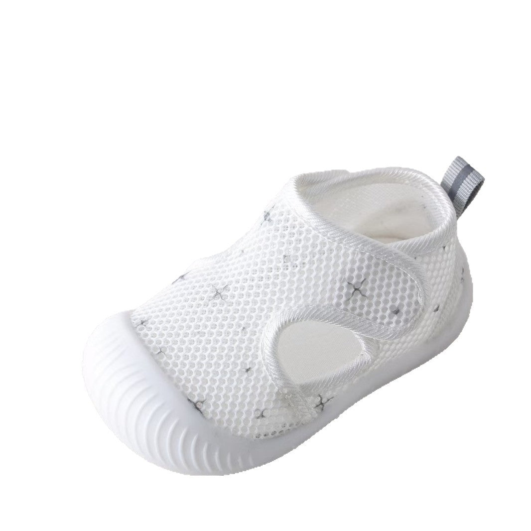 White baby shoe with mesh design on a white background