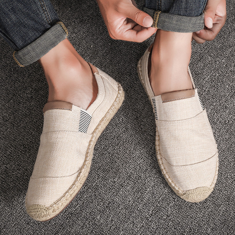 Beige espadrille shoes being worn on a textured surface
