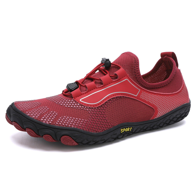 Red athletic shoe with black sole on a white background
