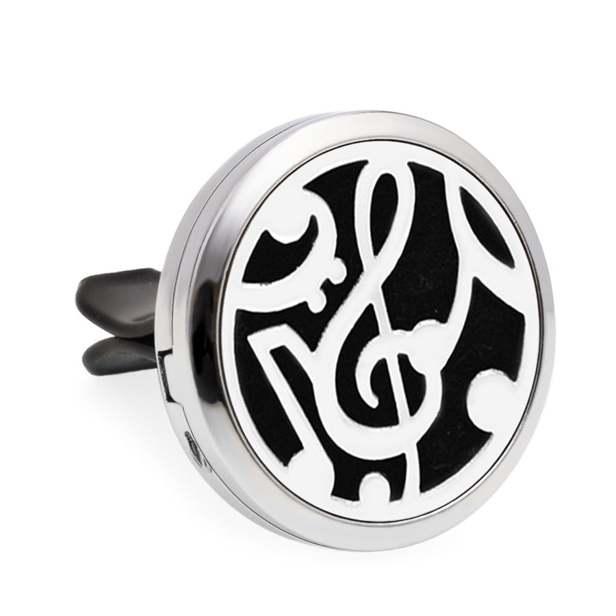Round silver and black music symbol diffuser on a white background