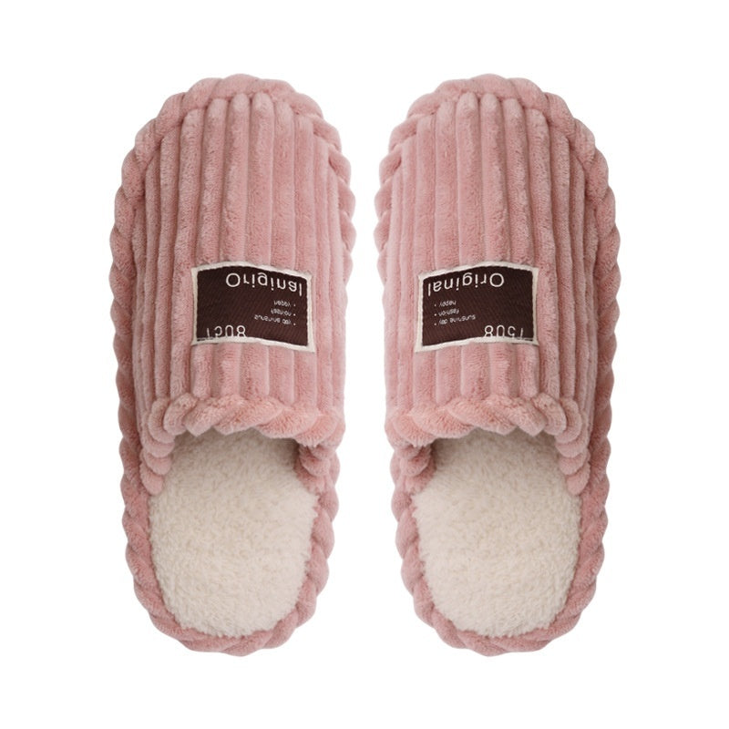 Pair of pink slippers with a white sole on a white background