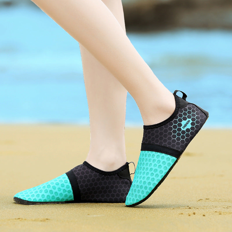 Teal and black beach shoes on a blurred beach background
