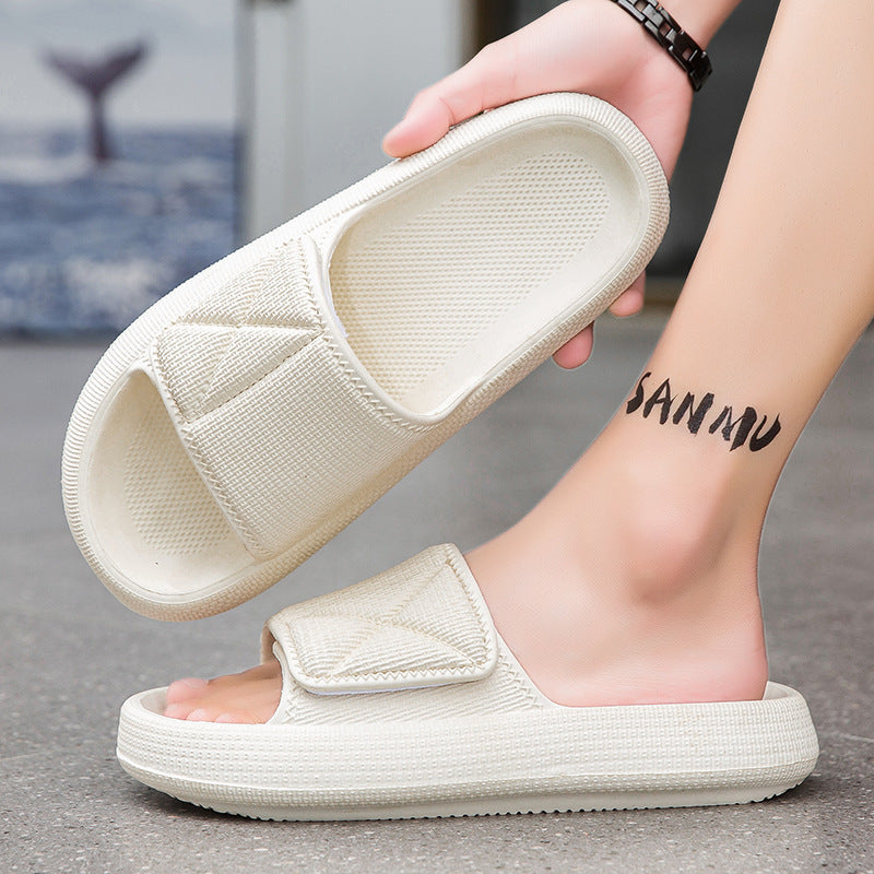 White slippers being held up with a blurred background