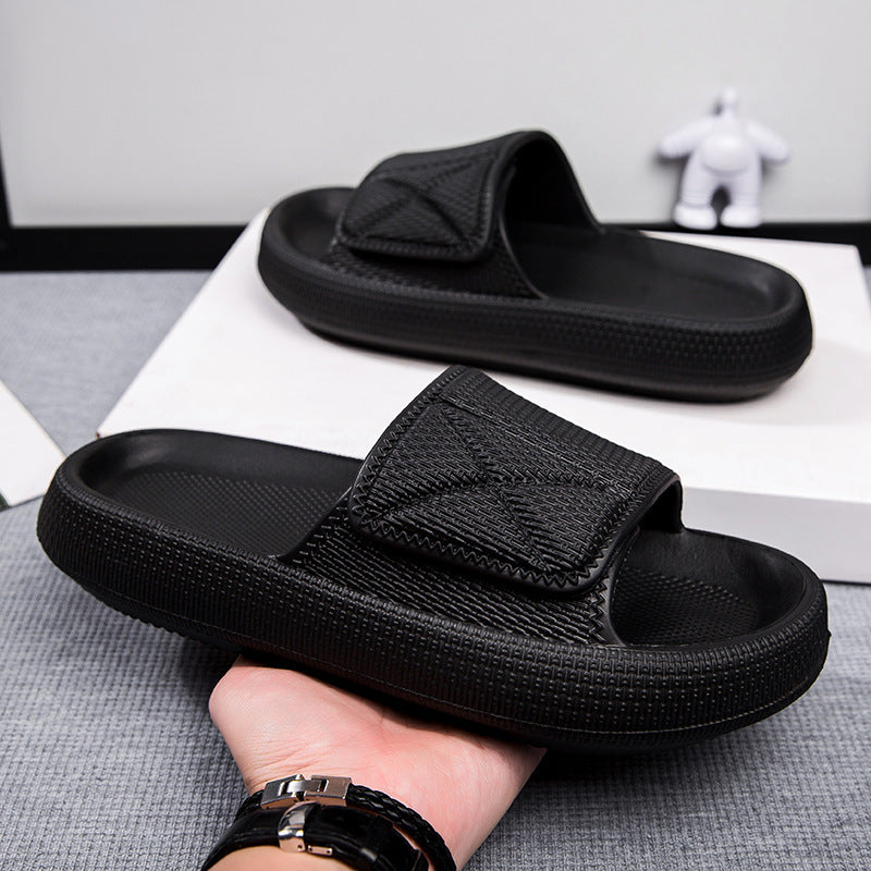 Black slides held by a hand on a gray surface with a white background