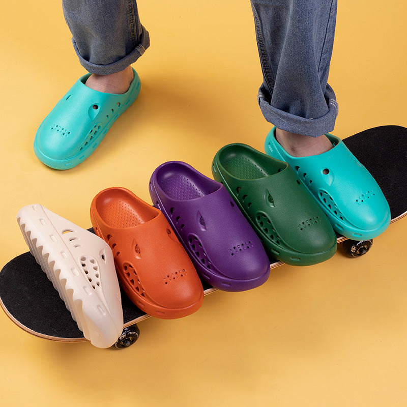 Colorful clogs on a skateboard with a yellow background