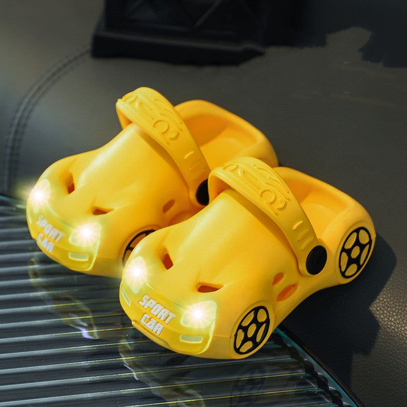 Yellow car-shaped slides with LED lights on a reflective surface