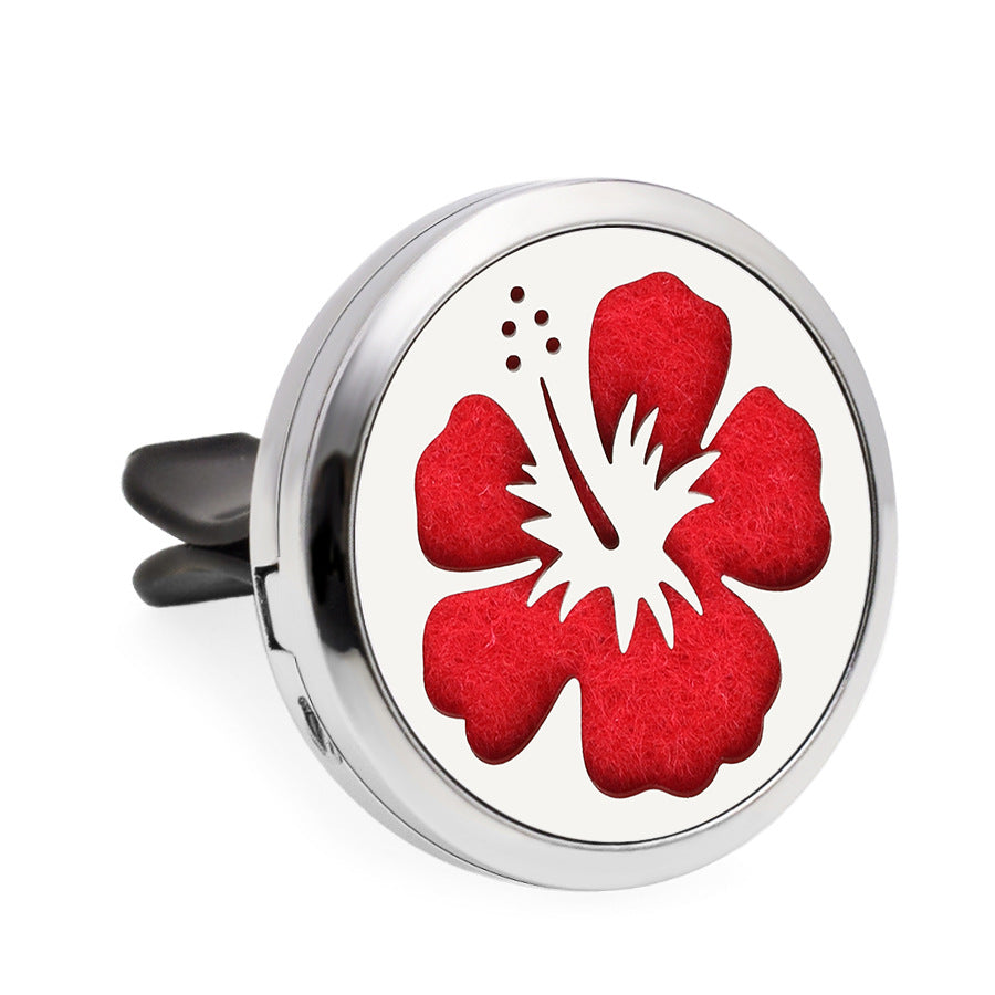 Round diffuser with red floral design on a white background
