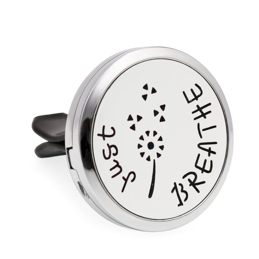 Round metallic diffuser with 'Just Breathe' text on a white background