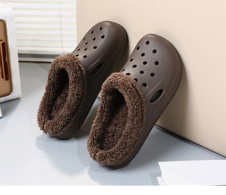 Pair of brown slippers with fuzzy lining on a light surface.
