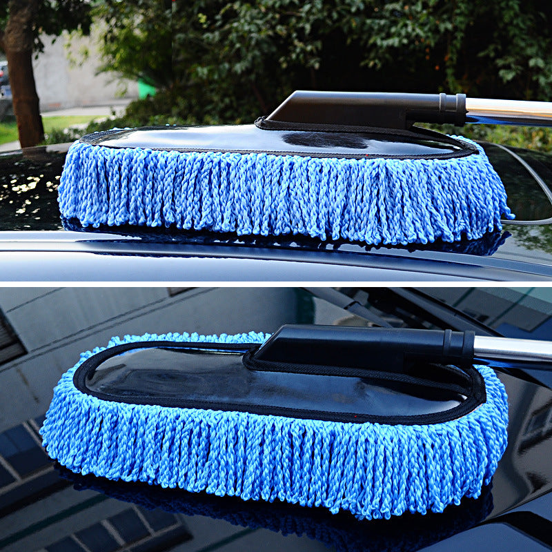 Car cleaning brush with blue microfiber pad on a car window