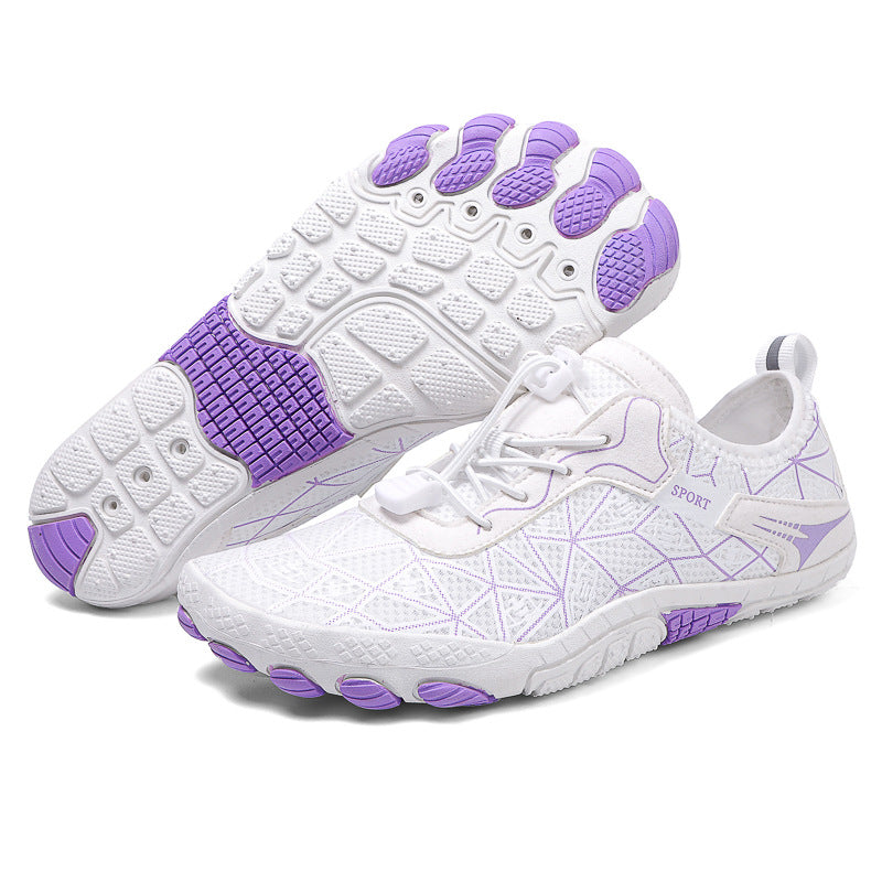 White athletic shoes with purple soles on a white background