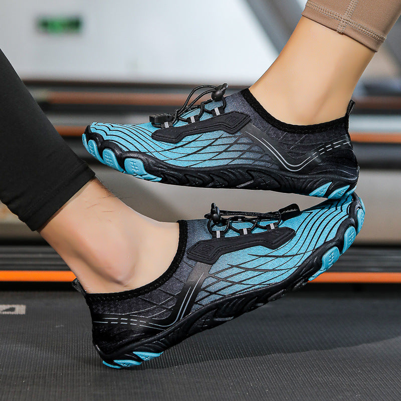 Black and blue athletic shoes worn by a person on a blurred indoor background