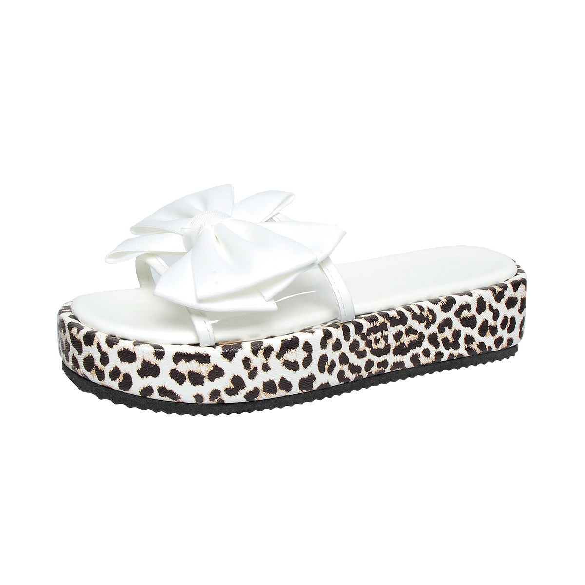 White sandal with a large bow and leopard print platform sole on a white background