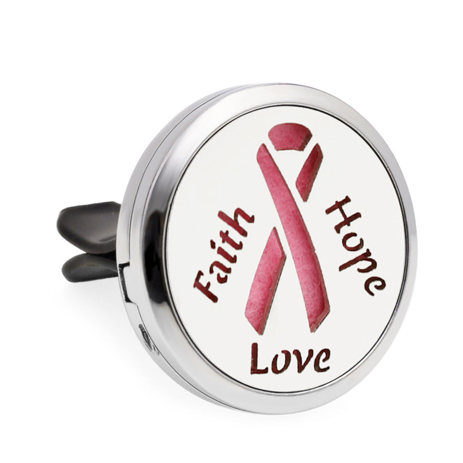 Round metallic diffuser with pink ribbon and 'Faith Hope Love' text on a white background
