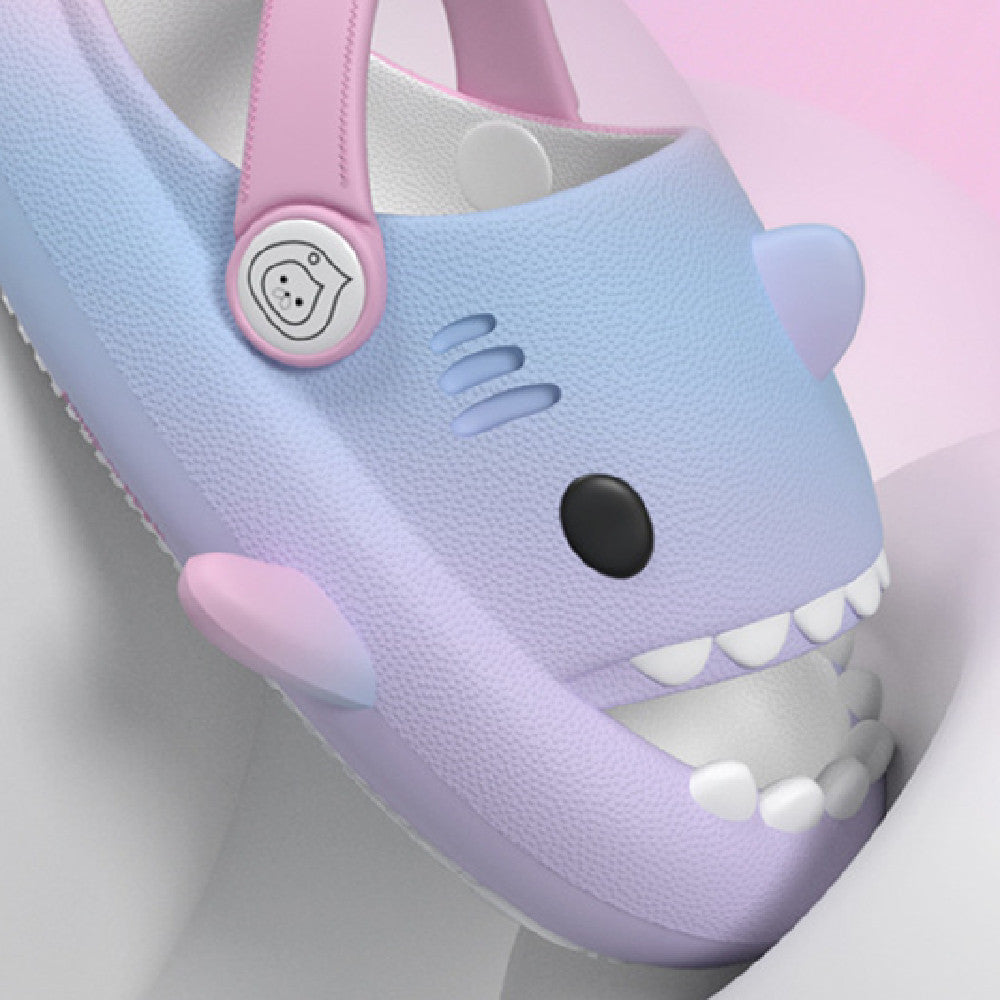 Children's shoe with shark design on a light pink background