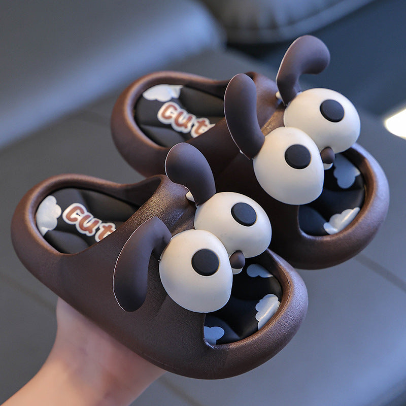 Pair of cartoonish brown sandals with white eyes and 'Cute' text held by a hand.