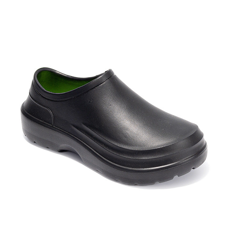 Black clog shoe with green lining on a white background