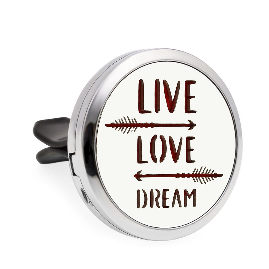 Round metal object with 'Live Love Dream' text and arrows on a white background